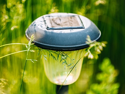 Nahaufnahme einer LED-Solarleuchte mit ein paar Grashalmen