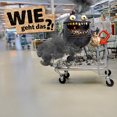 Ein Grill mit einem Gesicht befindet sich auf einem Einkaufswagen in einem Baumarkt